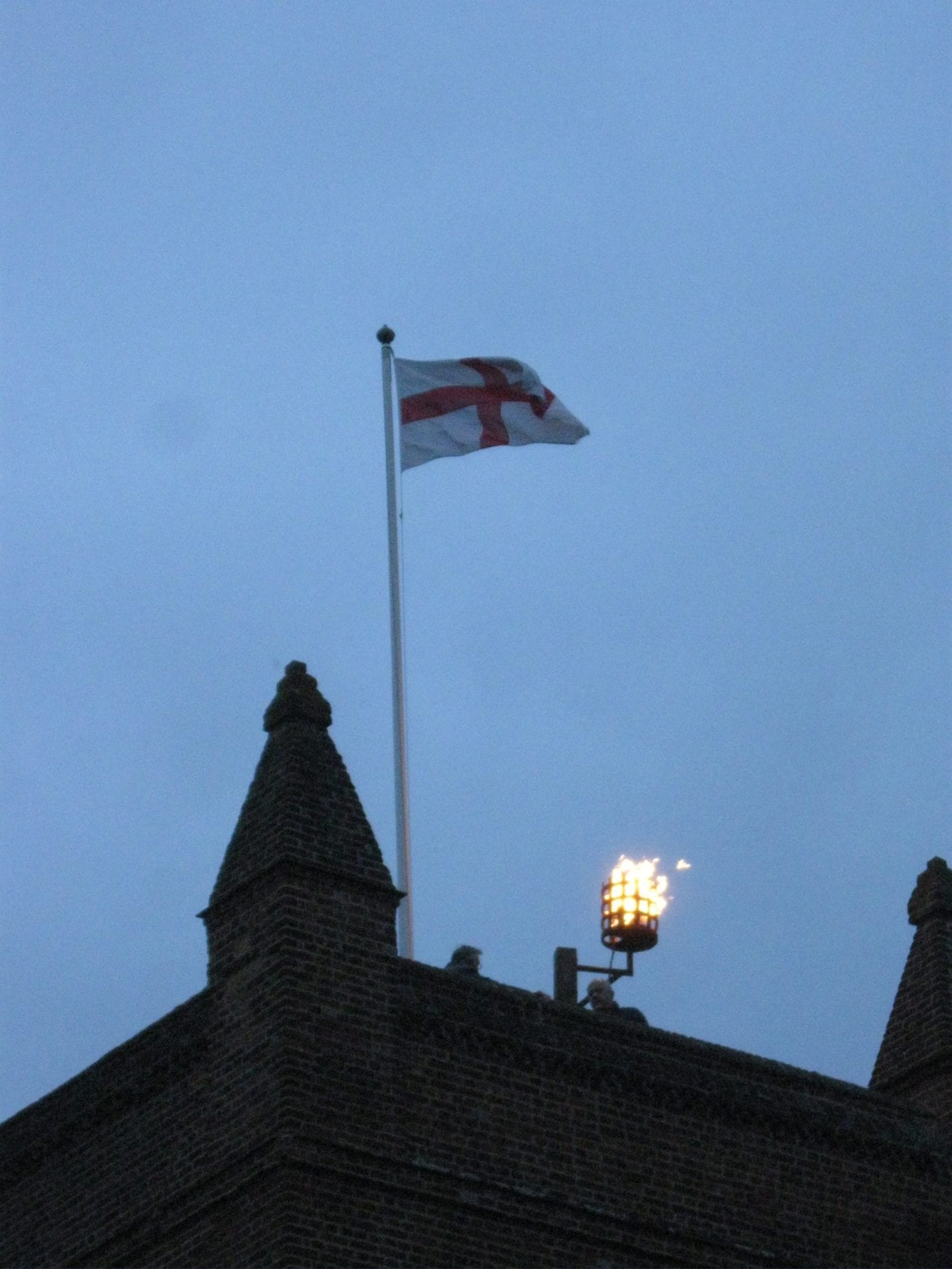 The lit beacon on top of St James church tower