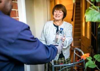 A customer on the priority services register receives bottled water . Picture: Thames Water