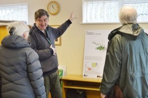 Cllr Andrew Grimes show plans to Shinfield residents.