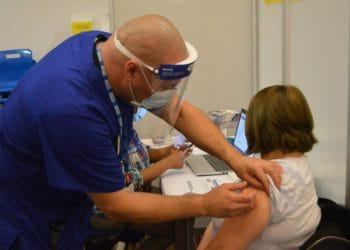 Jean McGuirk, 66, receives her first coronavirus vaccination Picture: Phil Creighton