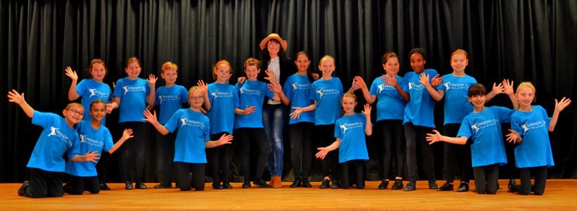 Emma Barton on the stage with members of Steppin out stars of tomorrow Wokingham