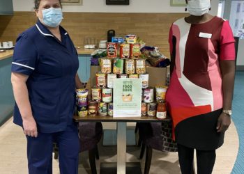 Natsayi, general manager and Gina, deputy manager of Austen House present  a collection of food donations. Picture: Austen House