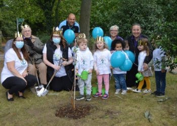 Freely Fruity's Matt Knight helps children from Honeysuckle Day Nursery and grown-ups fro Shinfield View care home to plant an apple tree as part of the Queen's Green Canopy