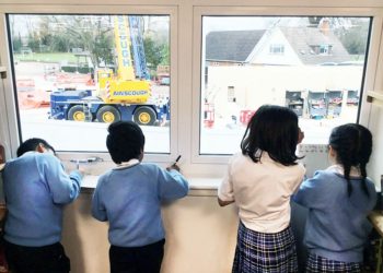 WATCHING: Young Crosfields pupils keep an eye on construction work on the school’s new buildings