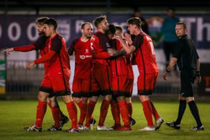 Sanchez Commock is mobbed after netting his second goal