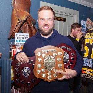 Shaun Thompson shows off his three trophies