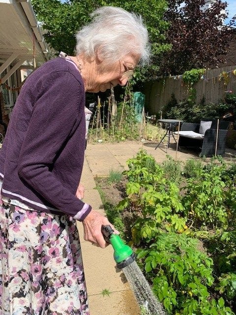 Resident Sheila Johnson, 81, watering the plants
in the Alexandra Grange garden.