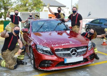 Firefighters get stuck into a charity car wash at Crowthorne Fire Station on Saturday Picture: Steve Smyth