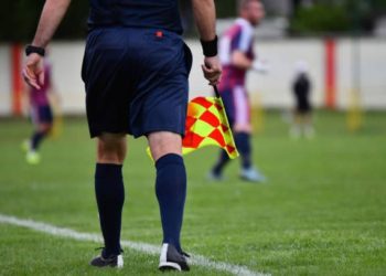 Assistant referee or Lineman of football or soccer holding flag