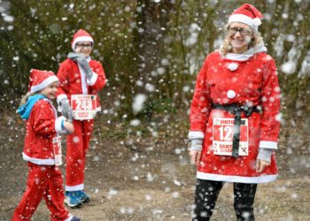Fun-runners enjoy the snow cannon in the finshers area Picture: Chris Drew