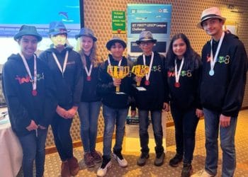 The members of team INOV8 Robotics show off their trophies after their First Lego League win