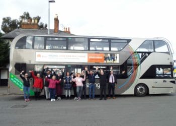 Members of Reading Buses and New Beginnings, including volunteers, in front of the branded bus