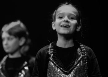A young performer enjoying being on stage at a Platform YP workshop