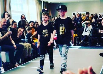 Archie (left) walks down the runway with older brother Dexter
