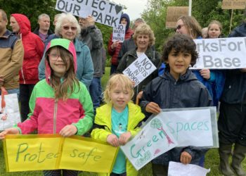 Woodley residents come together in the pouring rain to protest against plans to build a 5G mast in Vauxhall Park Picture: Phil Creighton