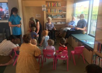 Shinfield View care home residents read to children who attend Storytime at the new School Green Centre. Picture: Ji-Min Lee