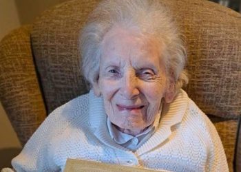 Irene Muggeridge (104) proudly holds up the pom-pom she created and the certificate that recognises her achievement at RMBI Care Co. Home Prince Philip Duke of Edinburgh Court, in Sindlesham