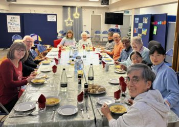 Enjoying the fruits of their labour, people sit down to chat and eat. Picture: Wendy Preston