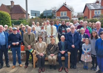 Parishioners and clergy of St Thomas More RC Church, Twyford and our Lady of Peace RC Church, Wargrave, with members of Father Vincent Flanagan?s family sitting on and beside the bench unveiled in his memory Picture: Sue Corcoran