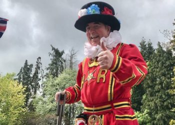 A Beefeater on stilts in the sunshine at WADE and WIN's coronation picnic. PIcture courtesy of Wokingham In Need