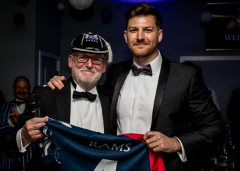 Rams' CEO Gary Reynolds presents the retiring Ollie Taylor with a shirt commemorating his 169 first-team games