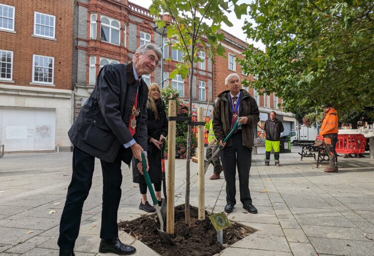 Cllrs Tony Page and Karen Rowland and Lord-Lieutenant Mr James Puxley laid soil on the tree to complete the planting ceremony. Picture: Jake Clothier