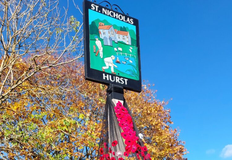 Hurst Hookers crochet and knitting group's display of poppies by the village pond