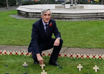 Sir John Redwood places a remembrance cross from Wokingham in the Garden of Remembrance in Westminster
