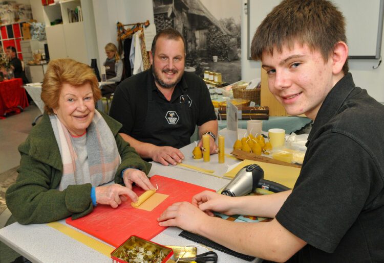 The MERL (Museum of Engish Country Life) Christmas Shopping Event last year saw Angela Francis making a candle with the help of Rob & Charlie Nickless Picture: Steve Smyth