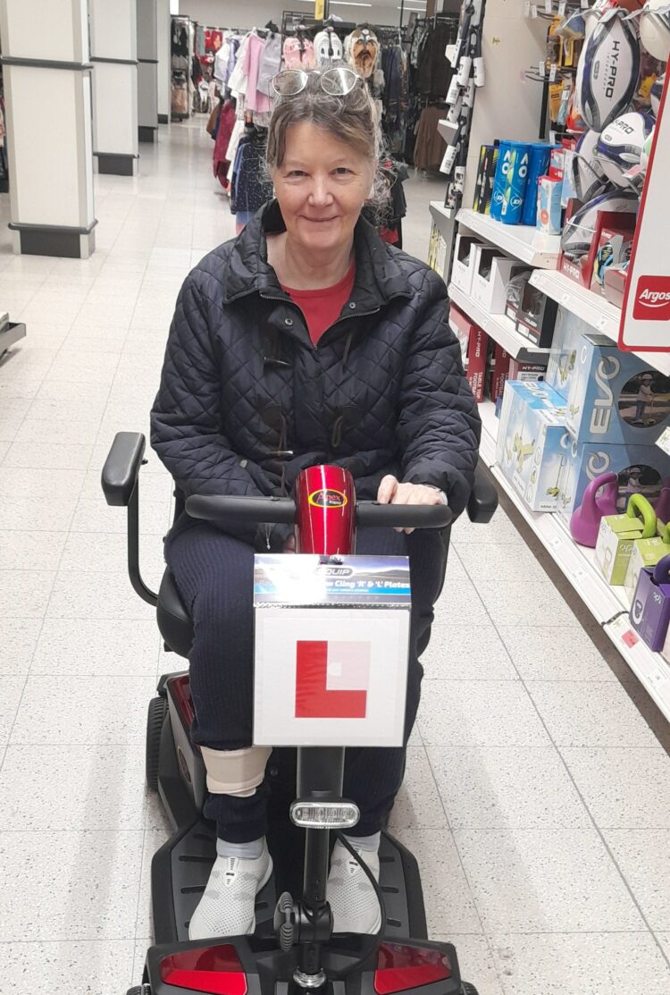 Pleased as punch, Elaine can visit the shops alone, thanks to support from WUC and W&E Lions Club, who helped her to buy a mobility scooter. Picture WUC