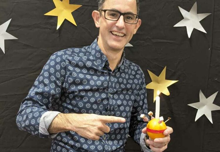 Pastor Nathan Hunt of Shinfield Community Church with a Christingle Picture: Joseph Creighton