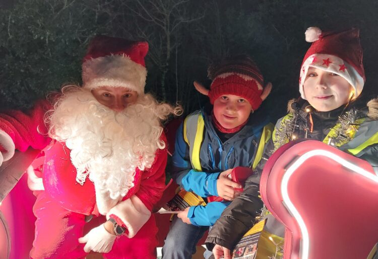Father Christmas was helped by Twyford Round Table, Oli Thomas, 13 and Sam Lee, 12 on his Hurst tour