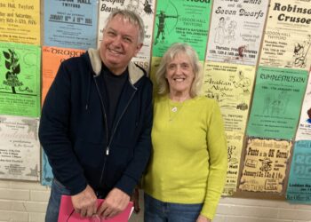 Pictured in front of historic panto posters are this year's Twyford panto are director and producer Peter and Beth Reynolds