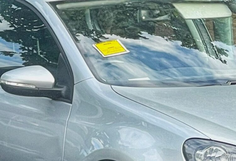 A car is issued with a parking enforcement notice in Wokingham.