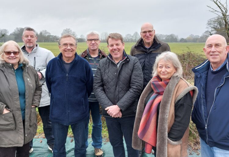 Hurst residents with their parish council chairman Wayne Smith. Behind them is the field they've helped protect from 200 homes being built. Picture: Sue Corcoran