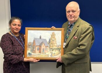 Dr Sean Beer presented a painting of the school to Bearwood Primary School headteacher Ms Funmi Alder. Picture: Bearwood Primary