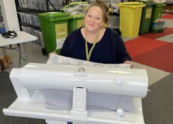 Volunteer Liz shows off the Cowshed's new rotary iron, donated by Nurture Landscapes Ltd. Picture: Emma Merchant