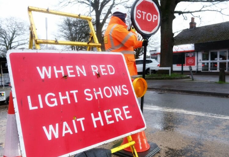 A worker operates the stop-go board on Wednesday morning.