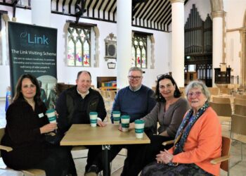 Lee Farmer, of Persimmon Homes Thames Valley, has a cup of coffee with Marjie Walker, a service user and Cllrs Cunnington and Weighill
