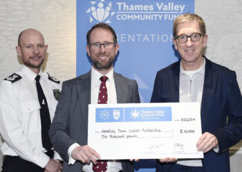 Brian Fennelly (right) receives the donation from Thames Valley Police
