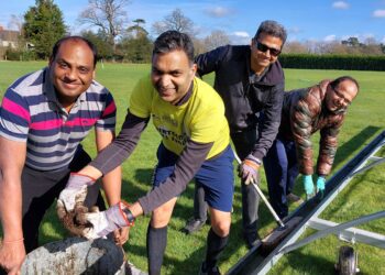 Nitin Goel, Vikas Gupta, Srini Rajasekaran, Vinay Acharya cleaning up the pitch covers at Hurst