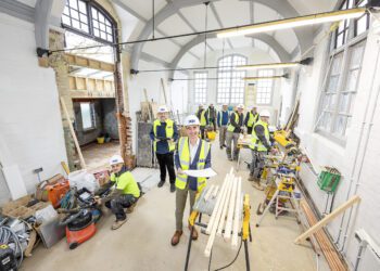 Cllr Stephen Conway, members of the project team and contractors in the main hall at the new Twyford Library. Pic: Stewart Turkington.