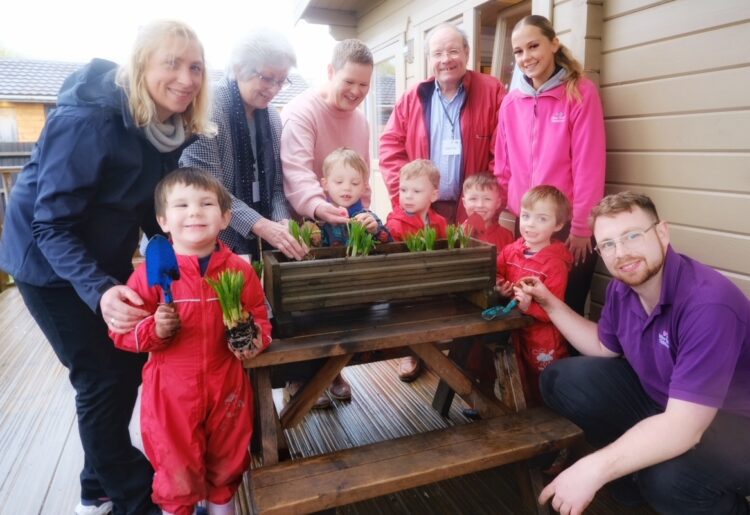 Children at Farm View day nursery in Spencers Wood with their visitors. pic: Andrew Batt.