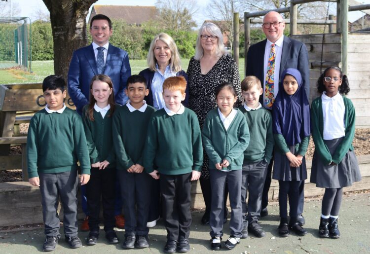 Howard Seymour, headteacher at Churchend Primary Academy, Elaine Hughes, headteacher at Hawkedon Primary School, Antoinette Butler-Willis, headteacher at South Lake Primary School, and Tom Bartlett, CEO of Orchard Learning Alliance; with pupils from Hawkedon Primary schools.