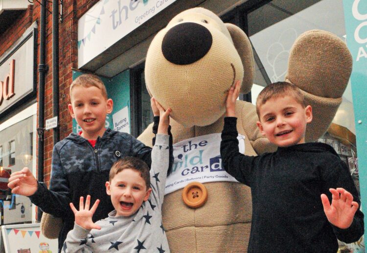 "Boofle The Bear" made a special visit to The Wild Card Shop in Wokingham to help celebrate its 35th anniversary. Pictured with him are Finnbar (9), Ted (4) and Eddie Reynolds (7) Picture: Steve Smyth