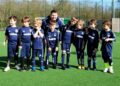 The U6s Hurst Spitfires football team looking forward to playing matches next season for the first time. They're pictured with coach Rob Dowding