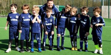 The U6s Hurst Spitfires football team looking forward to playing matches next season for the first time. They're pictured with coach Rob Dowding