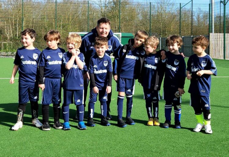 The U6s Hurst Spitfires football team looking forward to playing matches next season for the first time. They're pictured with coach Rob Dowding
