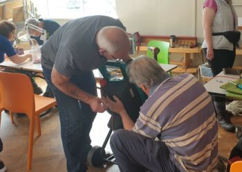 Fixers get to grips with a garden tool at the Woodley Repair Cafe. Picture: Woodley Repair Cafe