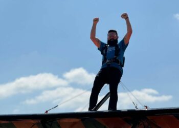 Ben Gee from Hat & Home is strapped in for a fundraising wing walk